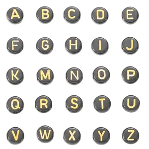Close-up of black and gold acrylic letter beads arranged in a 5x5 grid for DIY jewelry