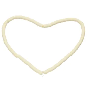 Macro shot of cream-colored polymer clay heishi beads arranged in a heart shape
