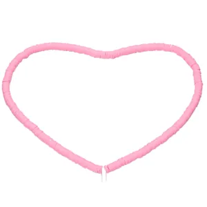 Close-up of pink polymer clay heishi beads arranged in a heart shape for DIY jewelry
