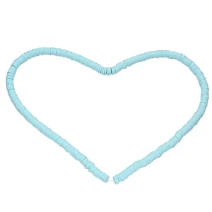 Detailed view of light blue 6mm Heishi clay beads arranged in a creative heart shape