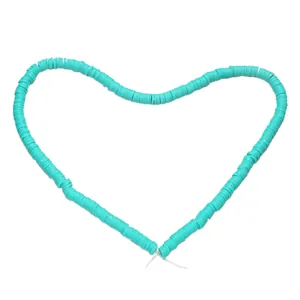 Heart-shaped arrangement of 6mm turquoise blue polymer clay heishi beads for DIY jewelry