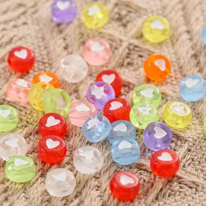 Macro shot of colorful resin heart beads with center holes for DIY jewelry making