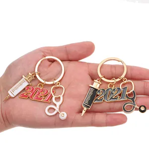 2021 medical theme metal keychain set featuring syringe, stethoscope and year pendants