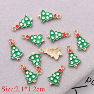 Detailed view of alloy Christmas tree pendants with green enamel and gold finish charms