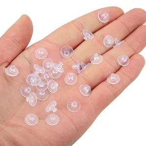Macro shot of transparent silicone earring backs on a hand for DIY jewelry making