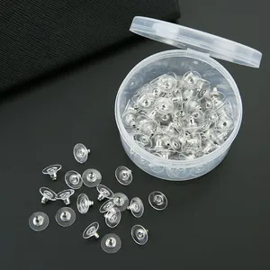 Clear PVC saucer-shaped earring backings with silver metal core in storage box