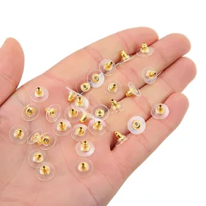 Clear silicone earbud backings with gold metal core held in hand for detail