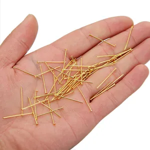 Gouden T-vormige kopsleuven voor DIY-sieraden maken getoond op een handpalm