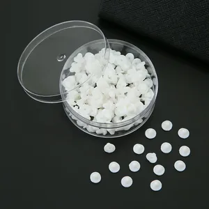 White PVC saucer-shaped earring backs in a transparent round box storage case