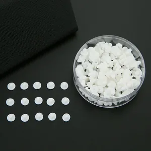 Bulk set of clear silicone butterfly earring backs in round storage box on black background