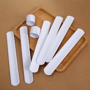 DIY white PVC slap bracelets set showing flexible curl and flat states for customization