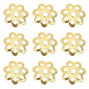 Macro detail of nine golden flower alloy bead caps for DIY jewelry making and crafts