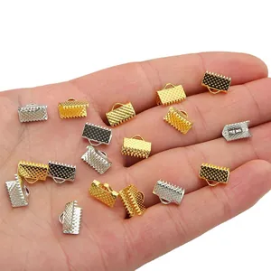 100 Stk. DIY-Bandklemmen in Gold und Silber in der Handfläche zur Darstellung der Größe