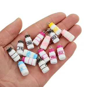 Detailed view of colorful mini resin milk bottle charms with metal hanging loops