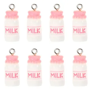 Detail showing eight pink and white resin strawberry milk bottle pendants in a grid layout