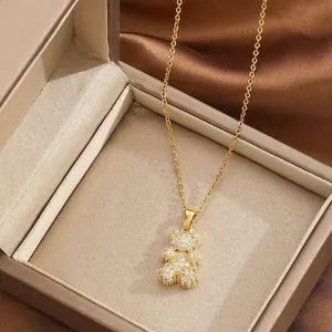 Golden teddy bear necklace with pave-set zircon pendant displayed in a premium jewelry box