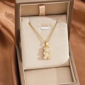 Elegant gold teddy bear necklace with pave zircons displayed in a luxury jewelry box