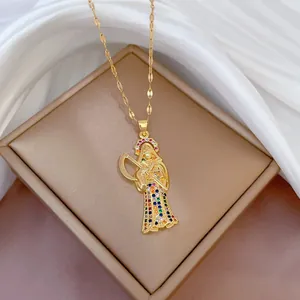 Golden Santa Muerte pendant necklace with colorful cubic zirconia on a jewelry box