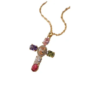 Elegant gold necklace with a cross pendant featuring colorful oval stones and white zircons