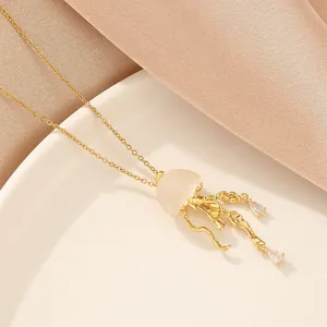 Exquisite gold jellyfish pendant necklace with zircon crystals and sleek cross chain