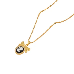Vintage cameo necklace with gold bow and crystal accents on a polished gold chain