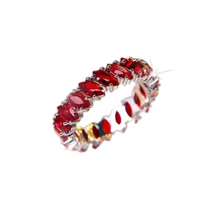 Eternity ring with marquise-cut red zircon stones set in a gold-plated copper band