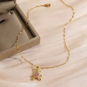 Gold bear pendant necklace with sparkling diamonds and a pink heart zircon stone