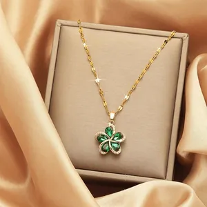Detailed macro view of golden flower necklace with green stones on silk lining