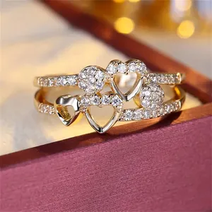 Macro shot of double-layer gold heart ring with micro-pave zircons on a jewelry box