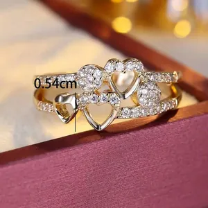 Macro detail of gold double-layered heart ring with zircon inlay and 0.54cm height mark