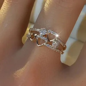Detail of gold-plated double-layer heart ring with micro-pave cubic zirconia accents