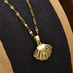 Macro shot of gold-plated shell pendant with pavé cubic zirconia and small pearl detail