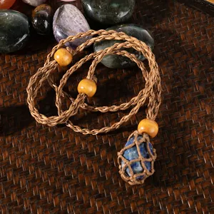 Handmade woven necklace with blue raw stone pendant in a cord mesh bag, ethnic style