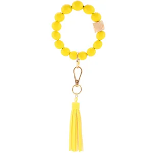 Detail of yellow silicone beads and wooden hexagon bead on a tassel keychain ring