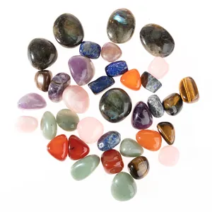 Detail of assorted polished natural crystals including rose quartz and tiger eye stones
