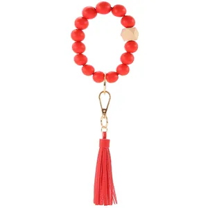 Red beaded wooden bracelet keychain with leather tassel and gold metal spring clasp