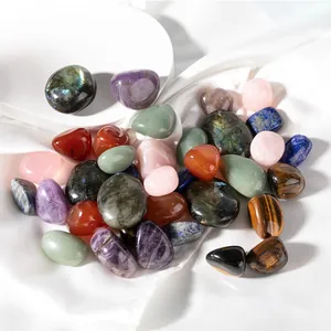 Macro view of polished tumbled natural crystals including rose quartz and tiger eye