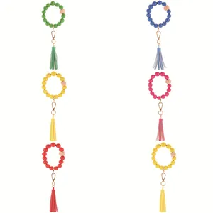 Detailed view of various color beaded bracelets with leather tassels and wood beads