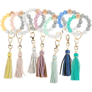 Close-up of colorful silicone bead wristlet keychains with wood beads and leather tassels