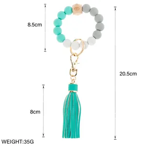 Beaded wristlet keychain with mint green silicone beads, wooden bead and tassel detail
