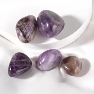 Close-up of five polished natural amethyst stones with unique textures on silk background