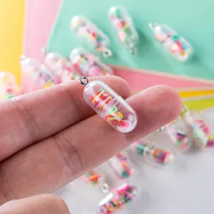 Macro shot of creative transparent pill capsule pendant filled with colorful fruit slices