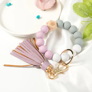 Beaded wristlet keychain with purple clay beads, wood hex bead, and stylish tassel charm