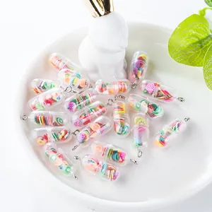 Macro shot of colorful fruit slices inside pill-shaped capsule charms for DIY jewelry making