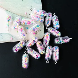 Macro detail of DIY capsule charms with rainbow bead fillings and metal loops