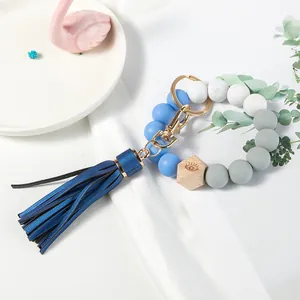 Blue and white silicone beaded wristlet keychain with wooden bead and leather tassel