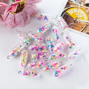 Macro detail of DIY pill charms with colorful beads and silver metal hanging loops
