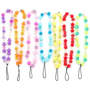 Close-up of colorful beaded phone straps with stars, smiley faces and faux pearls