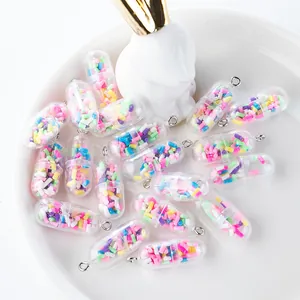 Detailed view of colorful pill capsule charms with glitter filling and silver metal rings