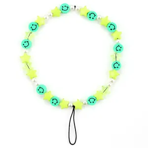 Detail of colorful beads lanyard with green smiley face, yellow star and pearls